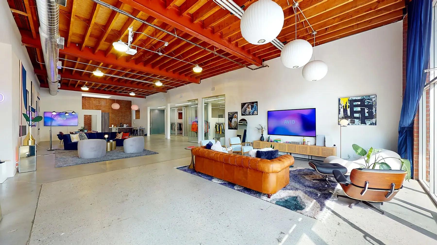 Creative-office lounge inside 1520 Cloverfield — brick, wood ceilings, skylights